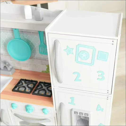 Cocinita KidKraft de madera blanca con detalles azul celeste, incluye horno, estufa y utensilios colgados, juguete infantil realista y educativo